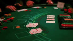 Live Baccarat dealer at jayabet apk studio, showing card shoe and betting layout with No Commission signage