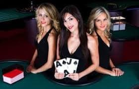 Roulette table with live dealer spinning wheel in Pretty Gaming studio.
